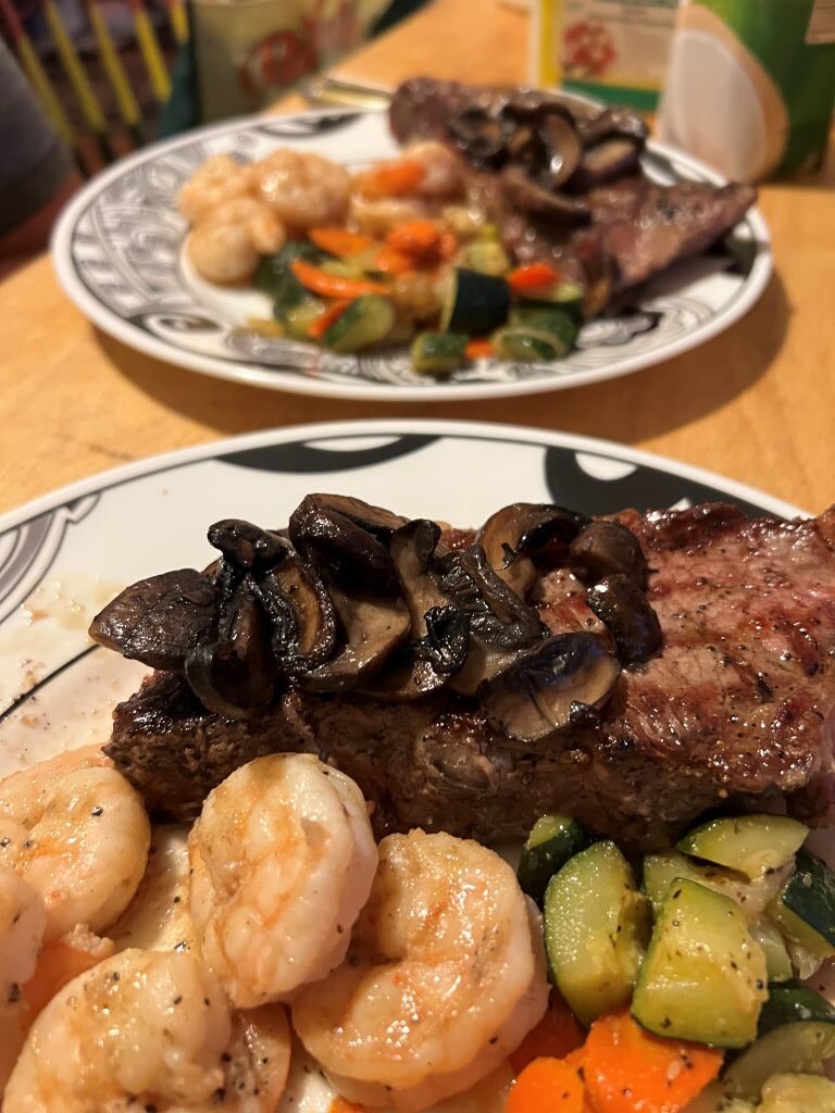 NY steak with braised mushrooms, lemon butter shrimp and sauteed zucchini with carrots