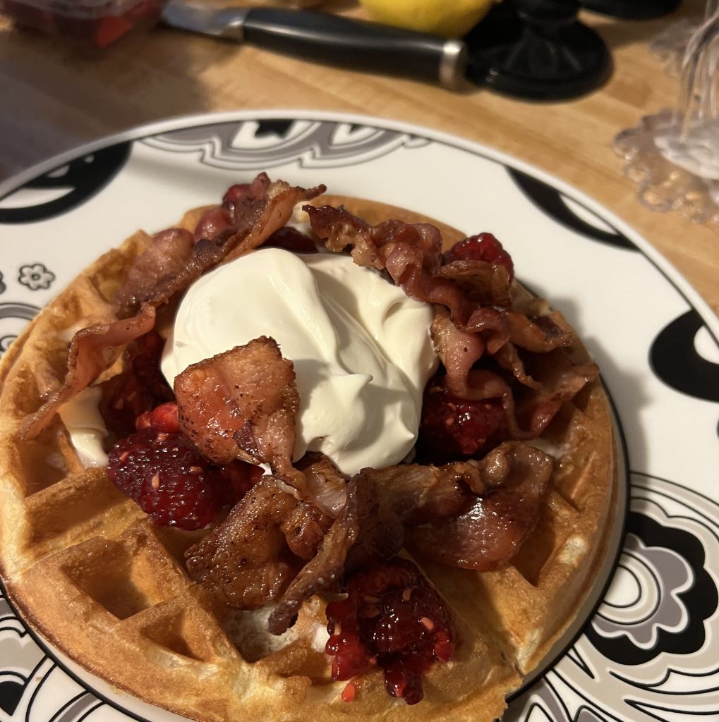 Belgian waffle with homemade bacon, raspberry compote and freshly whipped cream